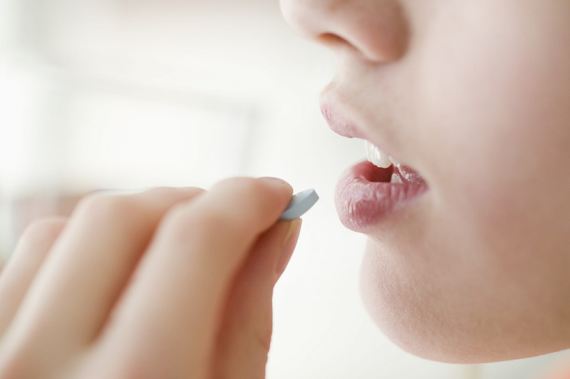 woman taking tablet